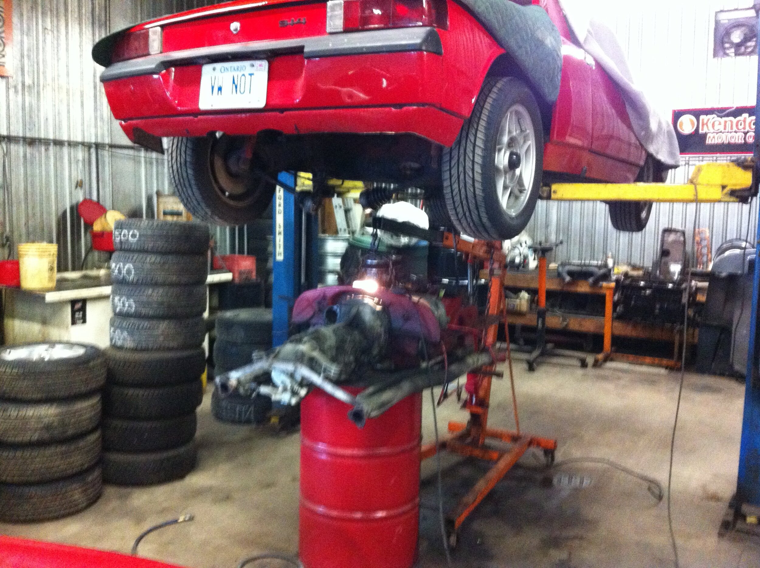 Red sports car on the hydraulic lift